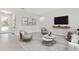 Bright living room with tile floors, neutral walls, and comfortable seating arrangement at 4627 Schoen St, North Port, FL 34291