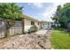 Backyard features a patio area with plants and a wheelbarrow, framed by a wooden fence at 475 Whippoorwill Dr, Venice, FL 34293