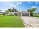 Charming single-story home featuring a well-maintained lawn, a concrete driveway, and attached garage at 475 Whippoorwill Dr, Venice, FL 34293