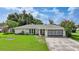 Charming single-story home featuring a well-maintained lawn, mature landscaping, and a two-car garage at 475 Whippoorwill Dr, Venice, FL 34293