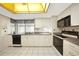 Well-lit kitchen with white cabinets, sleek appliances, and ample counter space at 475 Whippoorwill Dr, Venice, FL 34293