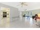 Open-concept living room with tile flooring and a seamless transition to the adjacent kitchen at 475 Whippoorwill Dr, Venice, FL 34293