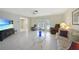 Inviting living room with neutral tones, tile flooring, and comfortable seating at 475 Whippoorwill Dr, Venice, FL 34293