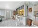 Inviting sun room with pass through window to kitchen, tile floors and lots of natural light at 475 Whippoorwill Dr, Venice, FL 34293