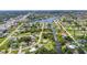 Wide angle neighborhood aerial view of properties near canals with tree coverage and residential streets at 769 Crestview Nw Cir, Port Charlotte, FL 33948