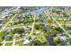 Aerial view showcasing a neighborhood with canal access, greenery, and a serene residential atmosphere at 769 Crestview Nw Cir, Port Charlotte, FL 33948
