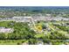 Aerial view of the home, lush landscaping, and access to nearby shopping at 769 Crestview Nw Cir, Port Charlotte, FL 33948