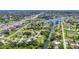 Expansive aerial view showcasing the neighborhood's layout alongside the canal, lush greenery, and local roadways at 769 Crestview Nw Cir, Port Charlotte, FL 33948