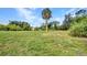 Expansive backyard with a mature palm tree and plentiful space for activities at 769 Crestview Nw Cir, Port Charlotte, FL 33948