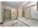Bathroom featuring a shower-tub combo with sliding glass doors, toilet, and sink with a large mirror at 769 Crestview Nw Cir, Port Charlotte, FL 33948