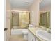 Bathroom featuring a shower-tub combo with sliding glass doors, toilet, and sink with a large mirror at 769 Crestview Nw Cir, Port Charlotte, FL 33948