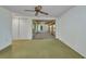 An empty bedroom with neutral carpet, ceiling fan, large sliding glass door, and built-in closet to the left at 769 Crestview Nw Cir, Port Charlotte, FL 33948