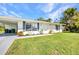 Single-story home featuring a well-maintained lawn and walkway with green landscaping at 769 Crestview Nw Cir, Port Charlotte, FL 33948