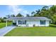 Inviting home with a manicured lawn and attached carport at 769 Crestview Nw Cir, Port Charlotte, FL 33948
