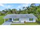 Charming single-story home with a well-maintained lawn, gray roof and blue shutters at 769 Crestview Nw Cir, Port Charlotte, FL 33948