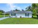 Charming home featuring blue shutters and a well-maintained lawn at 769 Crestview Nw Cir, Port Charlotte, FL 33948
