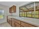 Kitchen with wood cabinets, solid surface countertops and a pass-through to the lanai at 769 Crestview Nw Cir, Port Charlotte, FL 33948