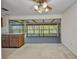 Open lanai with ceiling fan, lots of windows, and view into the kitchen at 769 Crestview Nw Cir, Port Charlotte, FL 33948