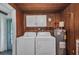 Functional laundry room with washer, dryer, and water heater at 769 Crestview Nw Cir, Port Charlotte, FL 33948