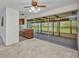 An airy living room with large sliding glass doors leading to a sunroom and partial view of the kitchen at 769 Crestview Nw Cir, Port Charlotte, FL 33948