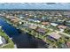 A sprawling aerial view of the property bordering the canal showcasing its location and manicured landscaping at 825 Via Tunis, Punta Gorda, FL 33950