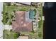 An aerial view showcases a lovely pool home with an enclosed lanai and lush backyard bordering the canal at 825 Via Tunis, Punta Gorda, FL 33950