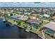 A fantastic aerial view of the canal-front property highlighting the outdoor pool, patio, and screened-in area at 825 Via Tunis, Punta Gorda, FL 33950