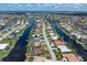 Beautiful aerial shot showcasing the property's waterfront location and its surroundings in a canal-filled community at 825 Via Tunis, Punta Gorda, FL 33950