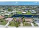 An elevated aerial view of the property displays its community and landscaping near the waterfront canal at 825 Via Tunis, Punta Gorda, FL 33950