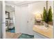 Bright bathroom featuring a vanity with decorative lighting and a decorative mirror, as well as a peek into the shower at 825 Via Tunis, Punta Gorda, FL 33950