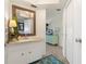 Bright bathroom featuring a vanity with decor, a stylish mirror, and a view into another room with a dresser at 825 Via Tunis, Punta Gorda, FL 33950