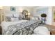 Bright bedroom with a patterned rug, upholstered seating, a full bed, and stylish decorative accents at 825 Via Tunis, Punta Gorda, FL 33950