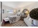 Bright bedroom with a patterned rug, upholstered seating, a full bed, and stylish decorative accents at 825 Via Tunis, Punta Gorda, FL 33950