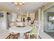 Charming dining area with white table, seating for four, and a view of the outdoor space at 825 Via Tunis, Punta Gorda, FL 33950