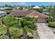 Lovely single-story home with mature landscaping, a tile roof and a two-car garage at 825 Via Tunis, Punta Gorda, FL 33950