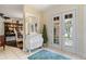 Bright foyer with white chest and tile floor, open to dining room and a clear view of the front entrance at 825 Via Tunis, Punta Gorda, FL 33950