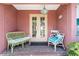Inviting front porch with seating creates a welcoming entrance to this home at 825 Via Tunis, Punta Gorda, FL 33950
