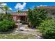 Charming front yard with a water feature and mature tropical landscaping at 825 Via Tunis, Punta Gorda, FL 33950