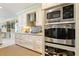 Gourmet kitchen with stainless steel appliances and custom cabinetry, designed for culinary creativity and efficiency at 825 Via Tunis, Punta Gorda, FL 33950