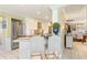 Charming kitchen featuring a breakfast bar, stainless steel appliances, and seamless connection to the adjacent dining area at 825 Via Tunis, Punta Gorda, FL 33950
