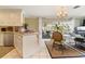 Bright kitchen with white cabinets, an island, and an adjacent casual dining area offering seamless indoor/outdoor living at 825 Via Tunis, Punta Gorda, FL 33950