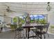 Screened lanai features a dining area, comfortable seating, and views of the lush landscaping at 825 Via Tunis, Punta Gorda, FL 33950