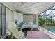 Covered lanai with daybed, lounge chair, and access to the pool at 825 Via Tunis, Punta Gorda, FL 33950