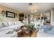 Open-concept living area with comfortable seating, views of the kitchen and lanai, and ample natural light at 825 Via Tunis, Punta Gorda, FL 33950