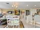 Airy living room features a chandelier and seamlessly connects the kitchen, dining area and living spaces at 825 Via Tunis, Punta Gorda, FL 33950