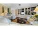 Comfortable living room featuring custom built-ins, shelving, and a cozy layout ideal for relaxation and entertainment at 825 Via Tunis, Punta Gorda, FL 33950