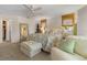 Well-lit main bedroom with tropical decor, ceiling fan, and comfortable seating for a relaxing space at 825 Via Tunis, Punta Gorda, FL 33950