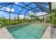 An inviting screened-in pool offers a refreshing retreat with clear water and a relaxing tropical atmosphere at 825 Via Tunis, Punta Gorda, FL 33950