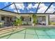 Relaxing poolside patio area featuring comfortable seating with a view of the crystal clear water of the pool at 825 Via Tunis, Punta Gorda, FL 33950