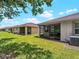 Expansive backyard featuring a screened lanai and well-maintained lawn for leisure activities at 8814 Tuscany Isles Dr, Punta Gorda, FL 33950